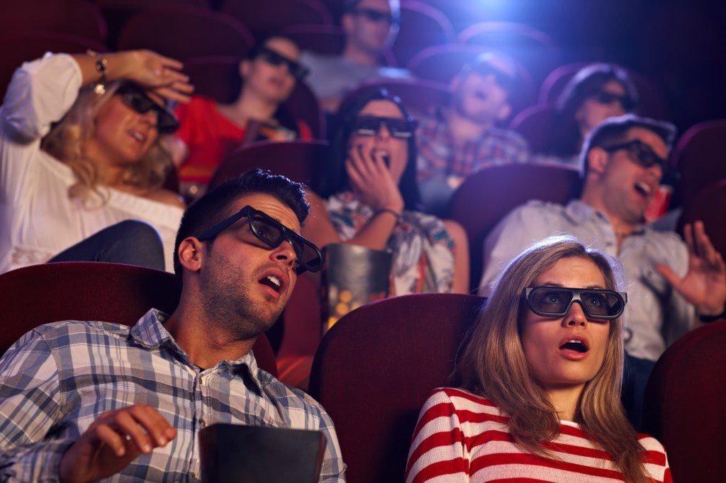 People in movie theater watching a 3D movie