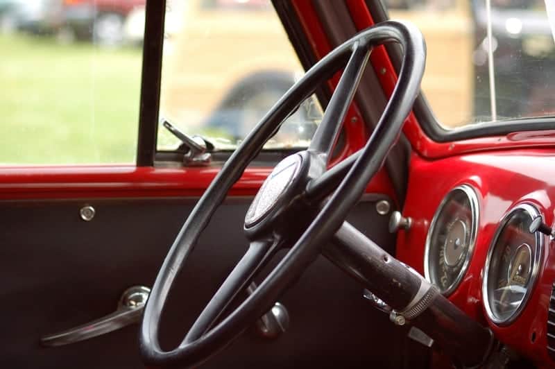 Steering wheel of classic red pickup truck 