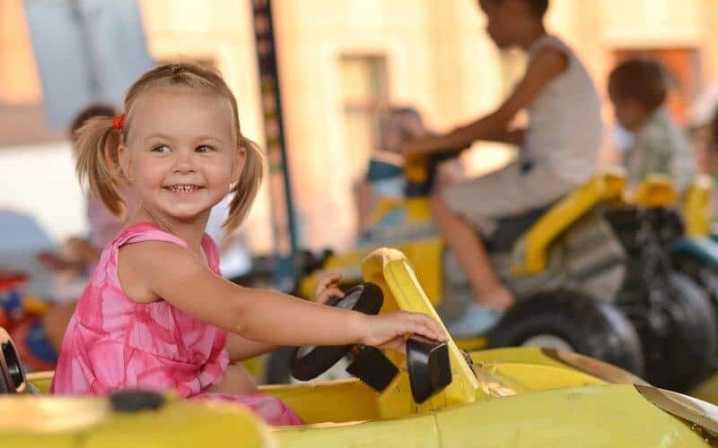 Girl on kiddie ride at amusement park