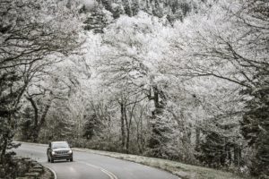 Car driving through the snowy mountains