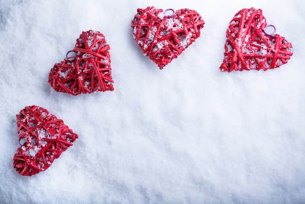 Red heart ornaments laying in the snow in Gatlinburg