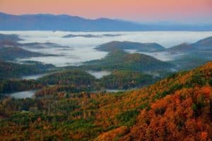 View of the Smoky Mountains int he fall with bright reds and oranges