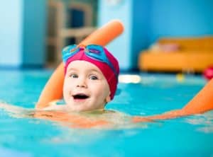 kid swimming in a Gatlinburg vacaiton rental with indoor pool