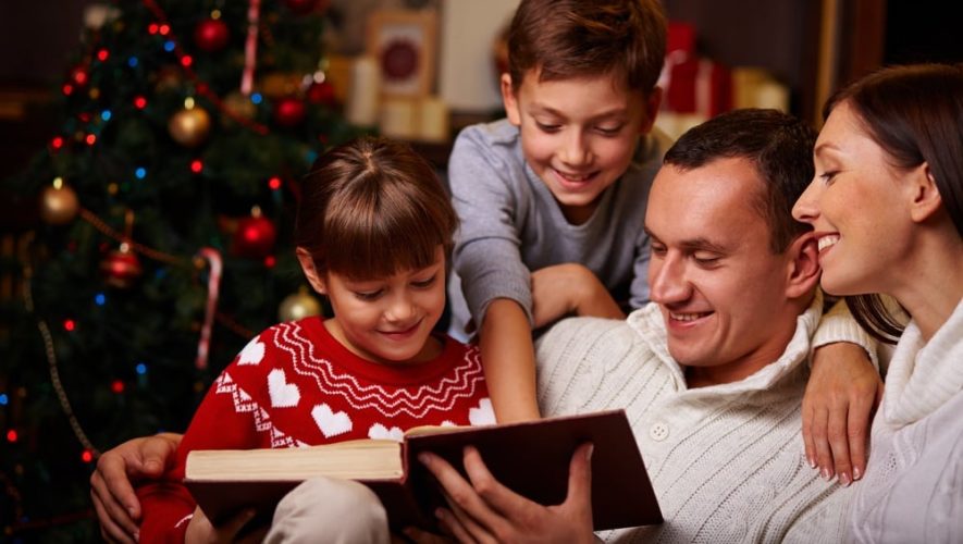 Family reading a holiday story together at our Smoky Mountain Christmas cabin rentals.