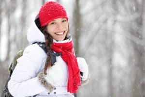 A smiling woman on a winter hike.