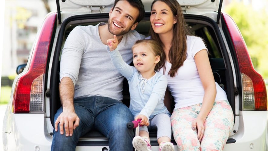 Happy family sitting in the boot of their car near our luxury vacation rentals in Pigeon Forge TN.