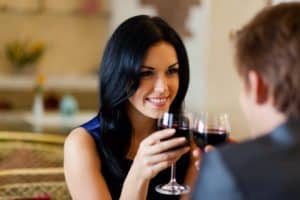 Romantic couple drinking red wine.