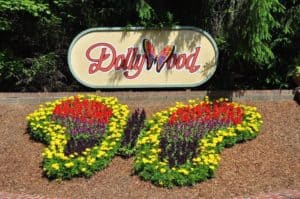 The sign and butterfly shaped flower display in front of Dollywood.