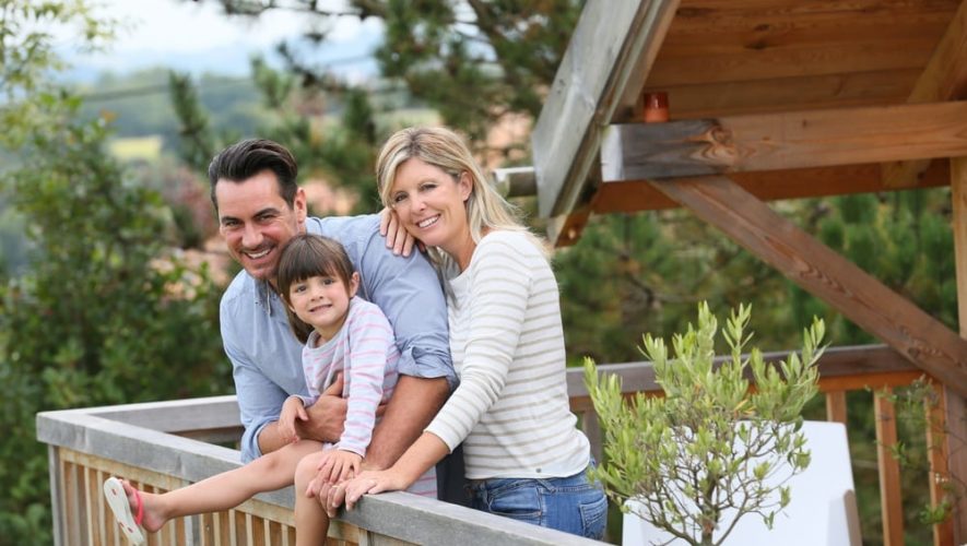 Happy family on the deck of a cabin.
