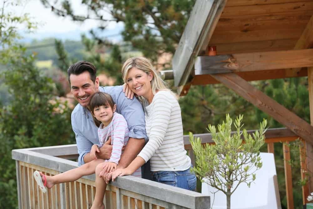 Happy family on the deck of a cabin.