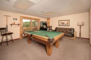 A pool table and an arcade system at a Pigeon Forge cabin.