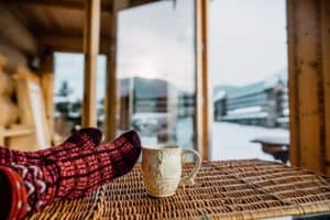 Person lounging with their socks at a cozy cabin