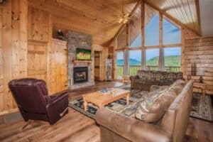 eagles perch living room with fireplace and mountain view from the windows